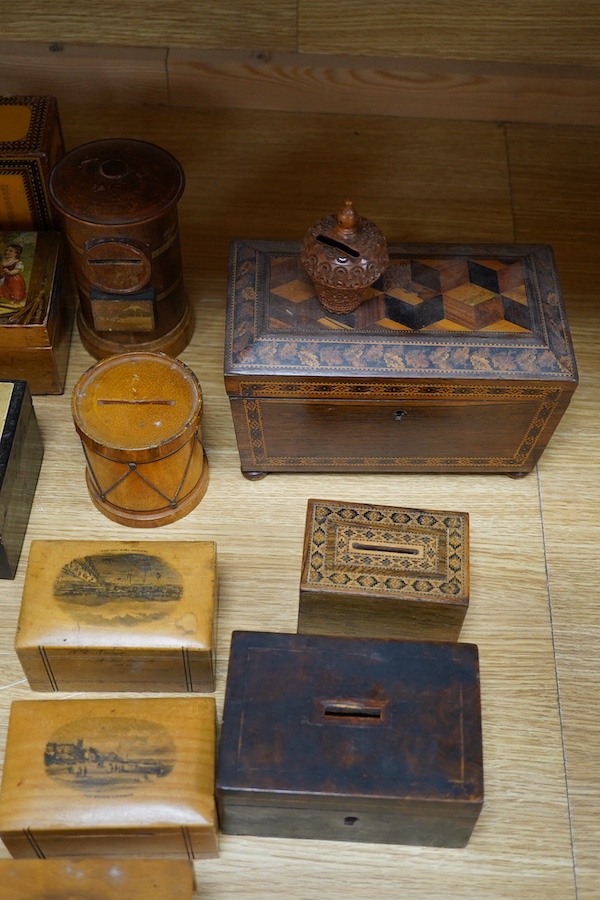 A 19th century Tunbridgeware tea caddy, 20cm wide, 11cm high, a Coquilla nut miniature money box and a collection of mixed decorative and novelty wooden money boxes (17). Condition - poor to fair